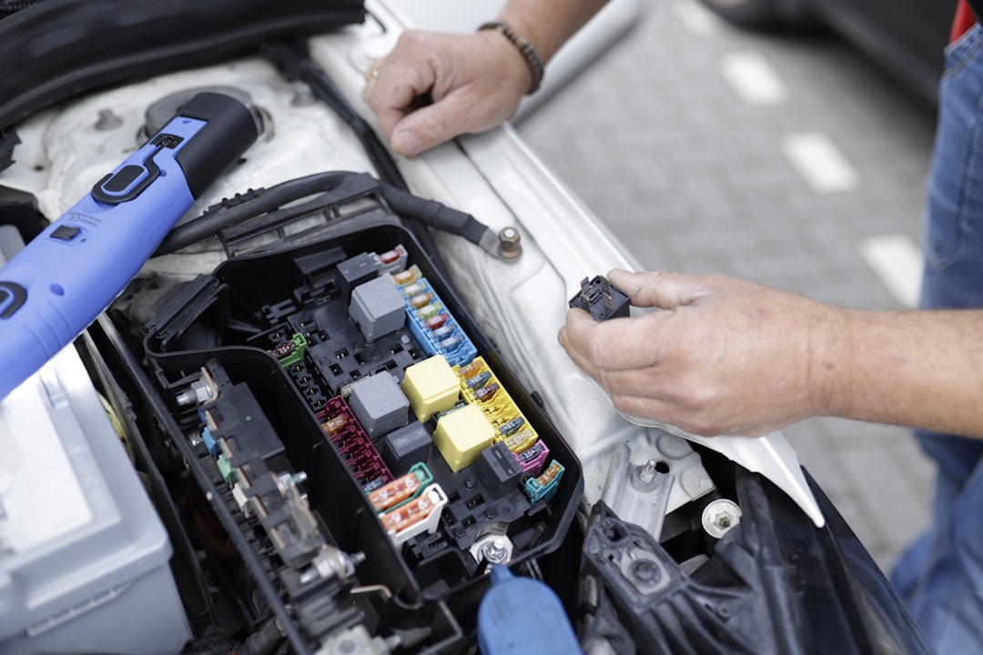 digital Car mechanic working on a cars electronics.